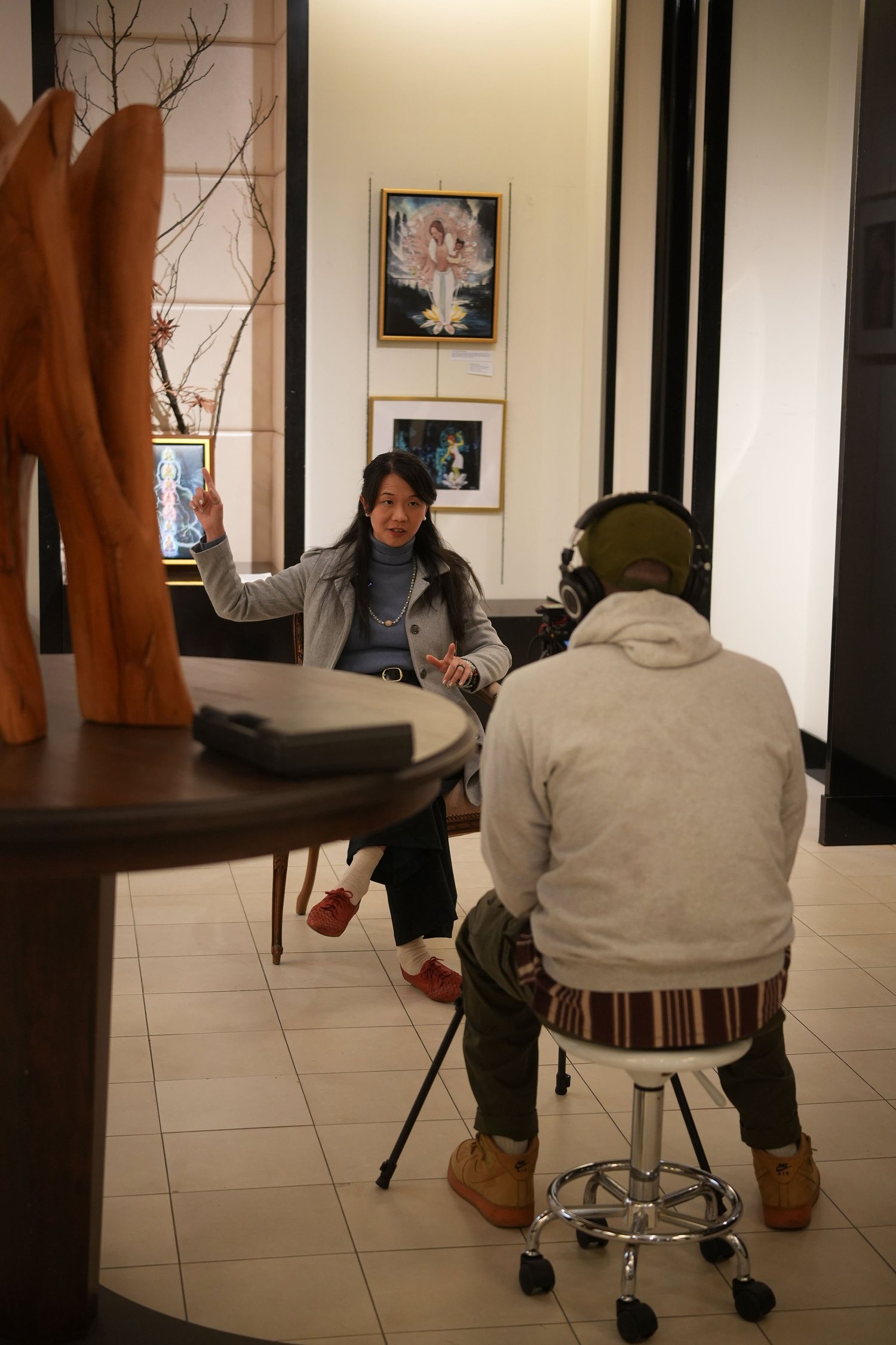 A participant speaks during a recorded conversation in the gallery.