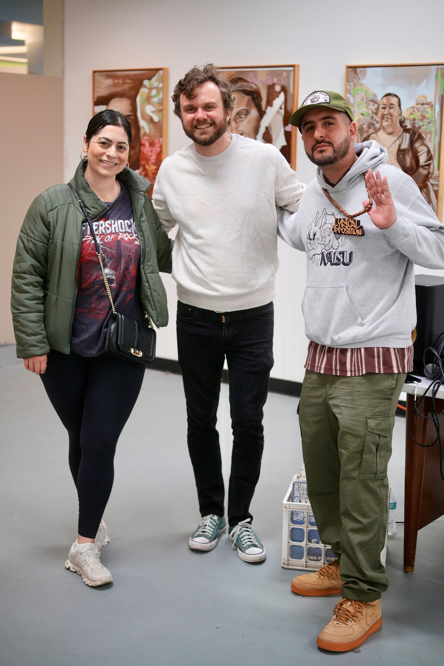 Guests smile together for a portrait in the gallery.