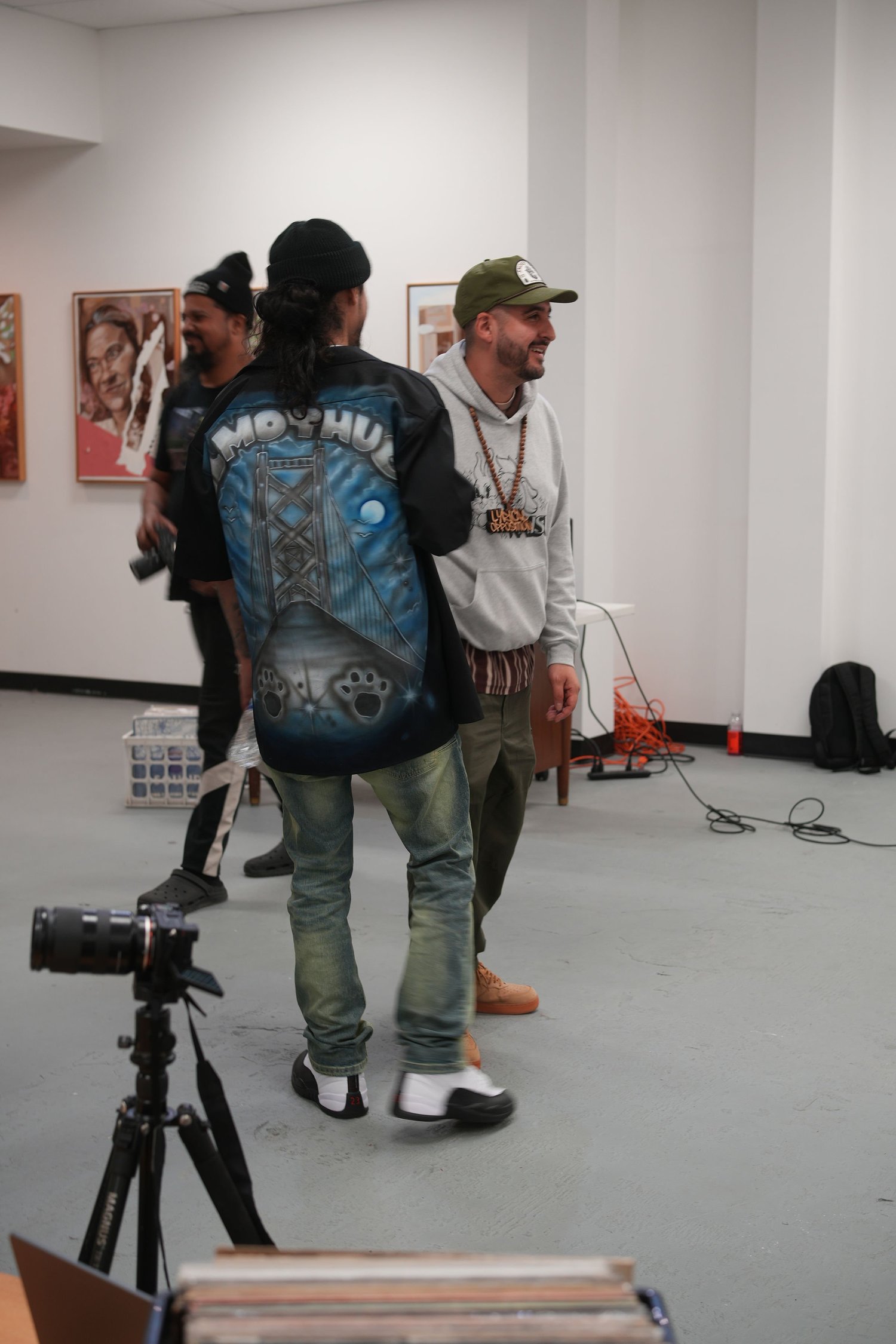 A visitor wearing an illustrated jacket studies the exhibition.