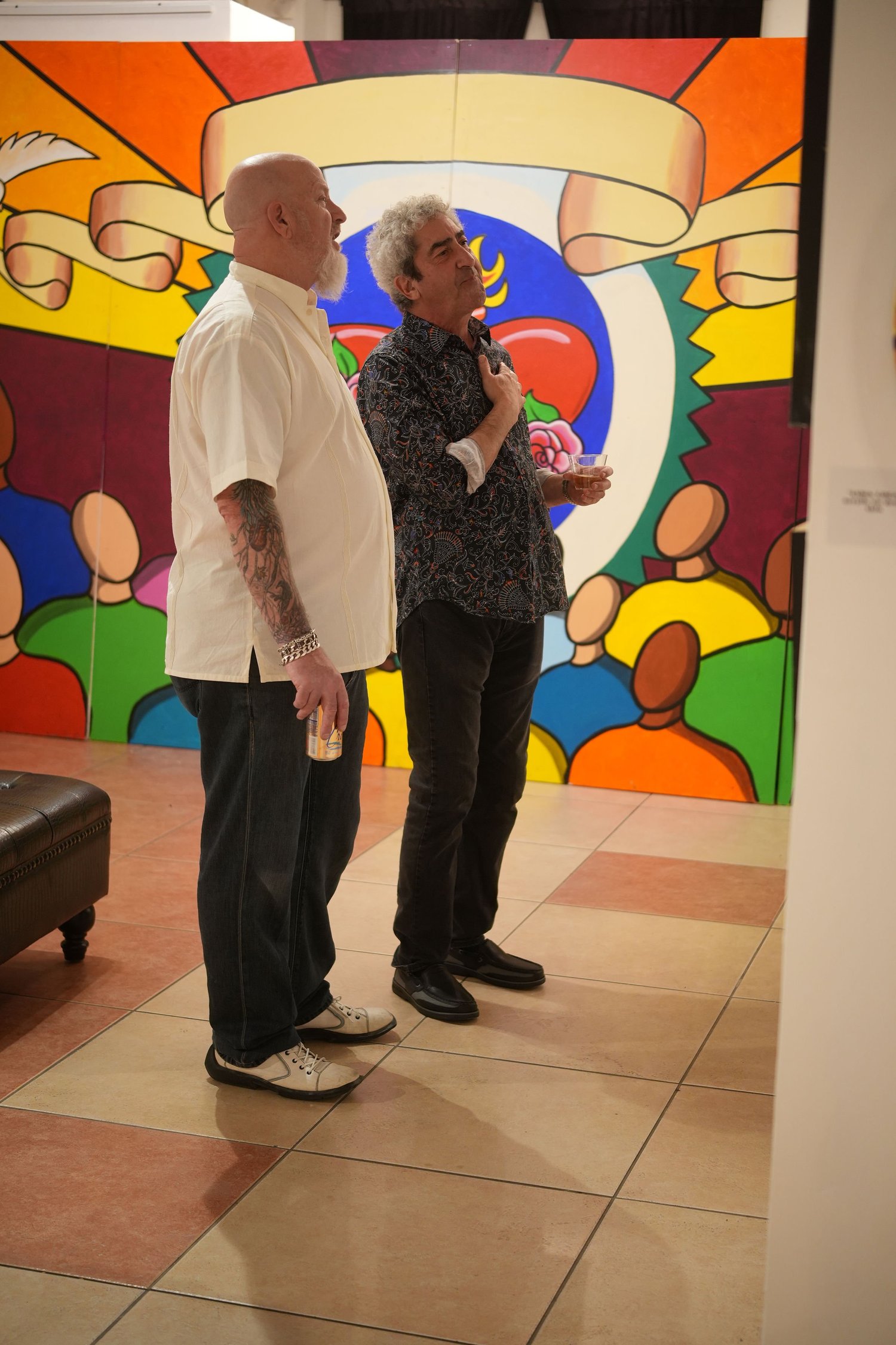 Visitors converse in the art-filled exhibition space.