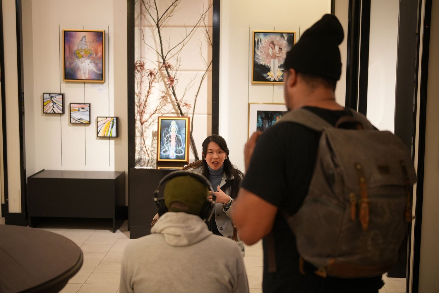 A camera operator records a seated interview.