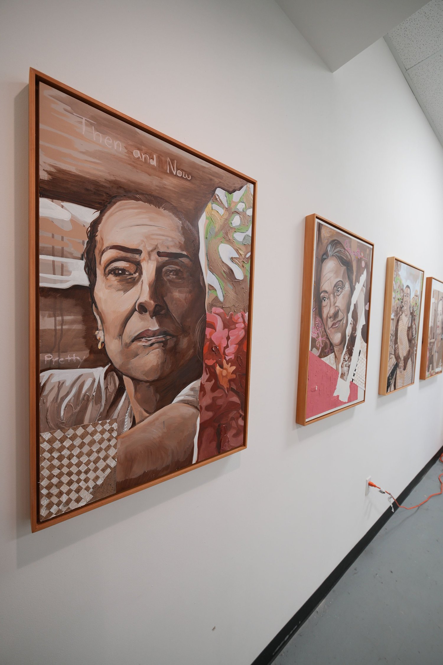 Framed painted portraits displayed in a row.