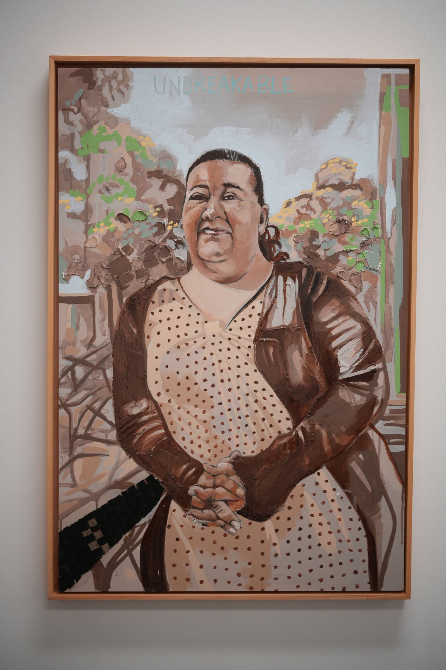 A framed painted portrait of a person standing outdoors.