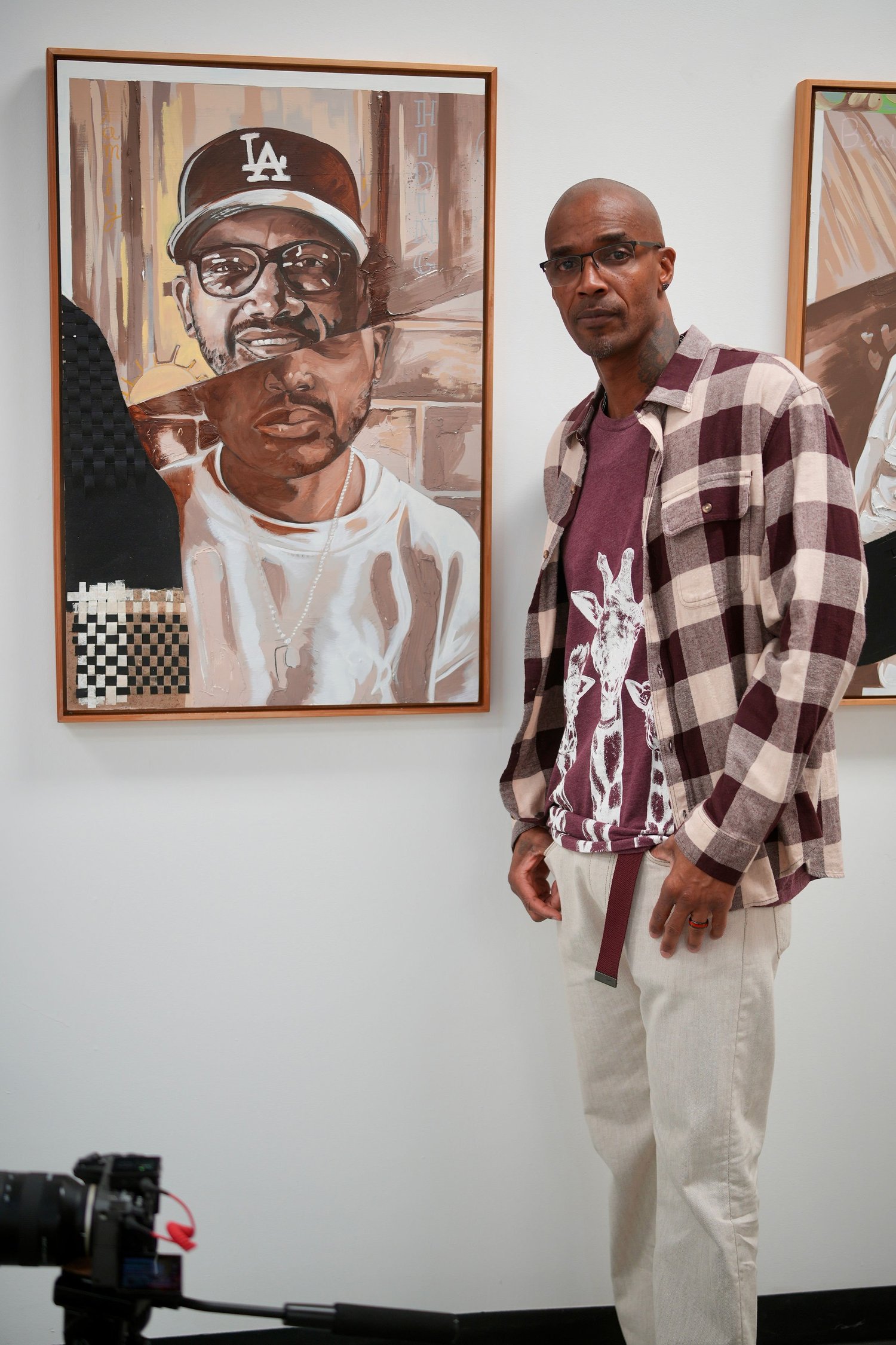 A speaker addresses gallery visitors with a microphone.