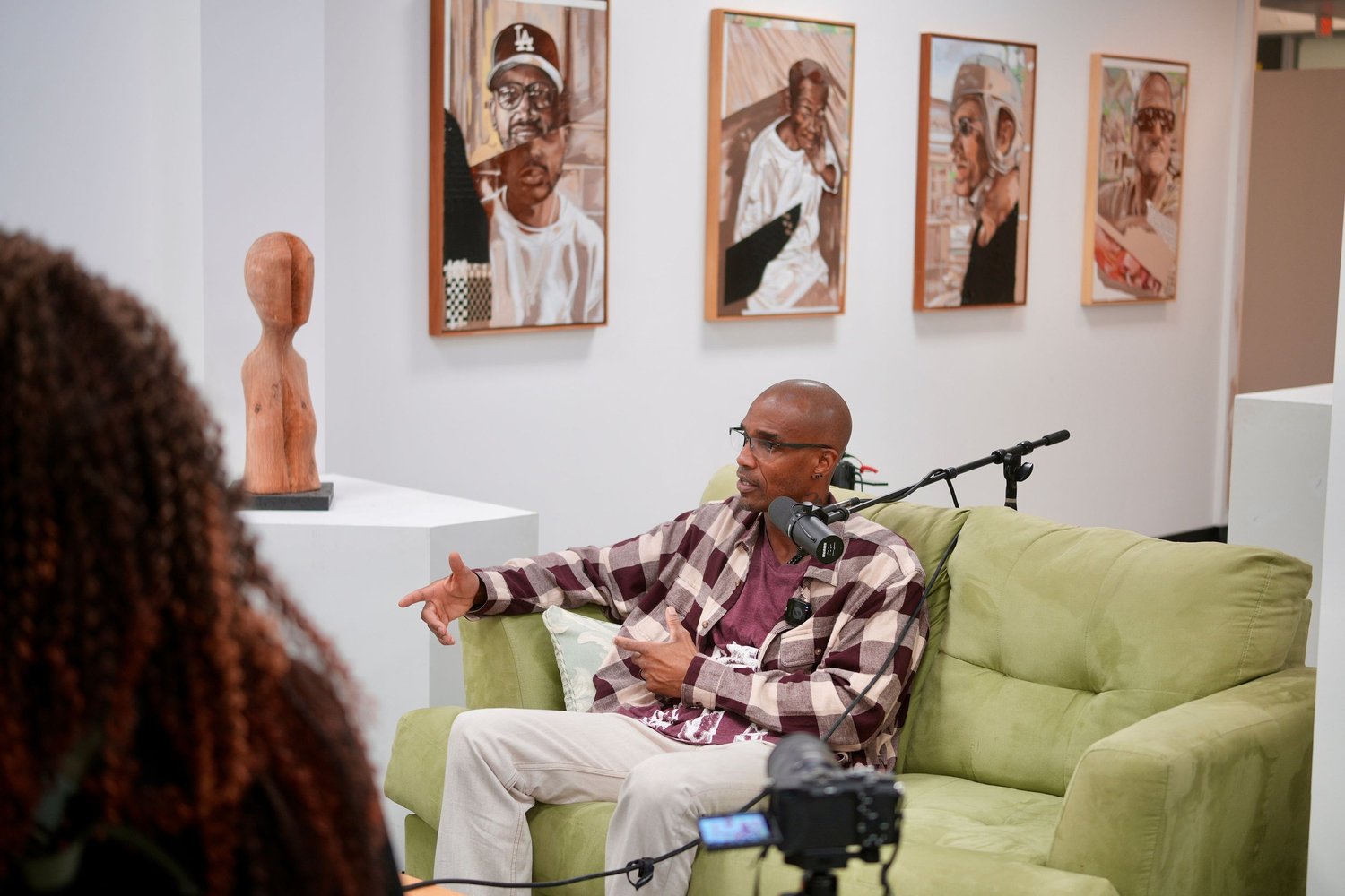 A participant speaks during a recorded conversation in the gallery.