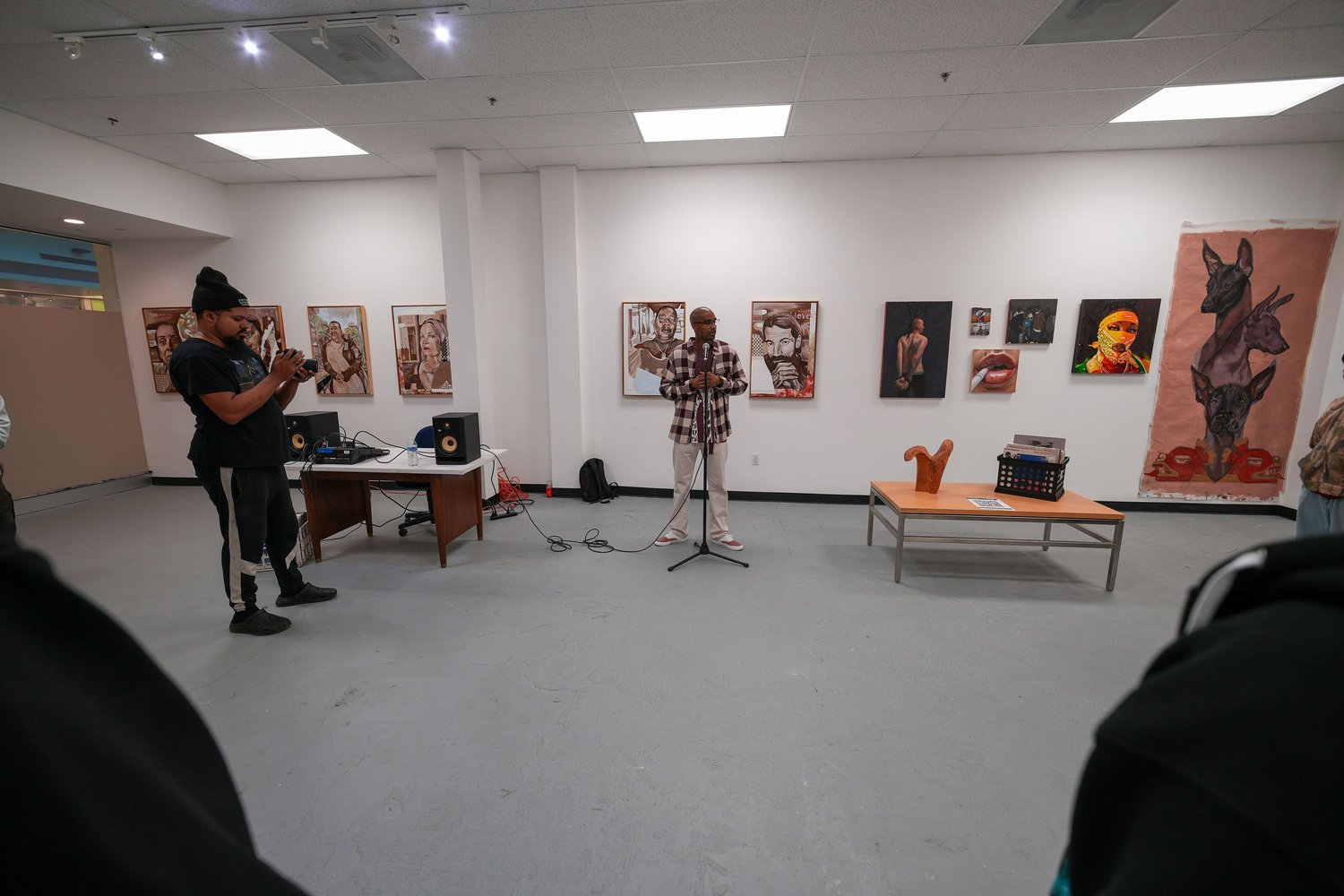 Guests gather and talk among the displayed artwork.