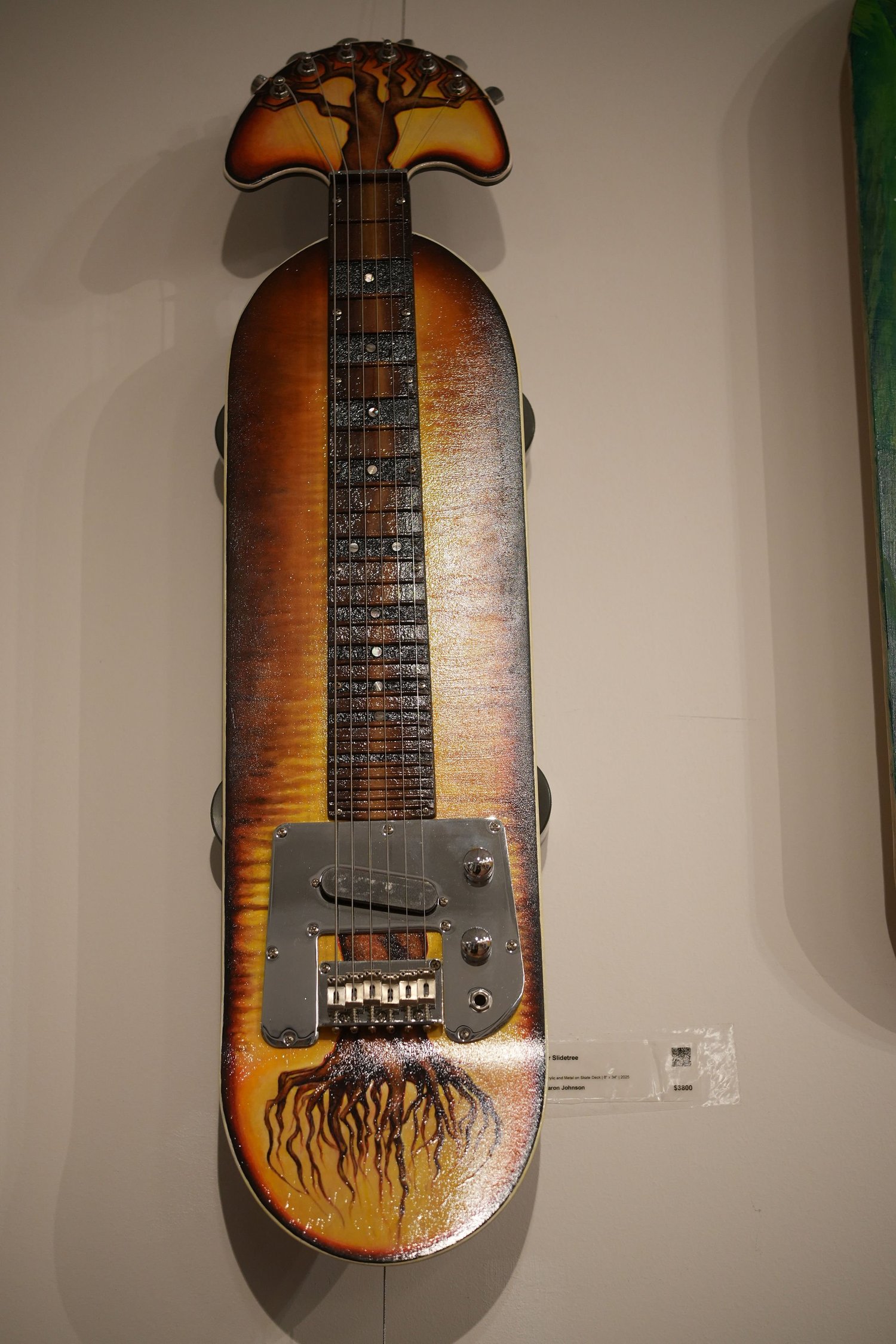 A skateboard deck transformed into a stringed instrument.