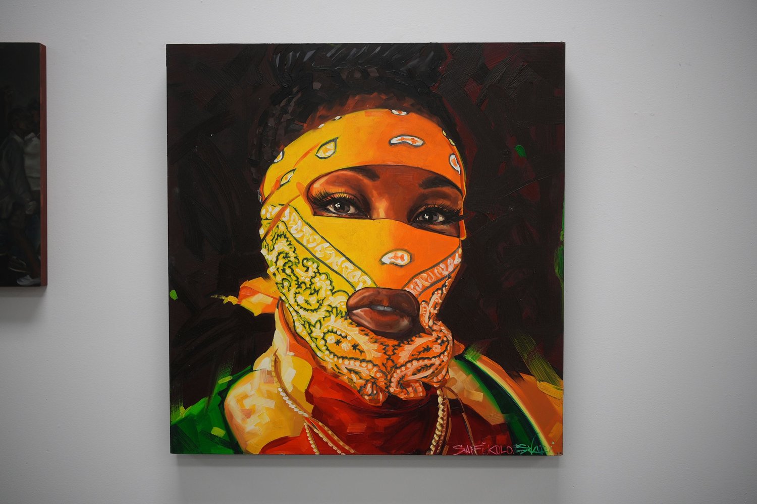 A painted portrait with an orange patterned face covering.