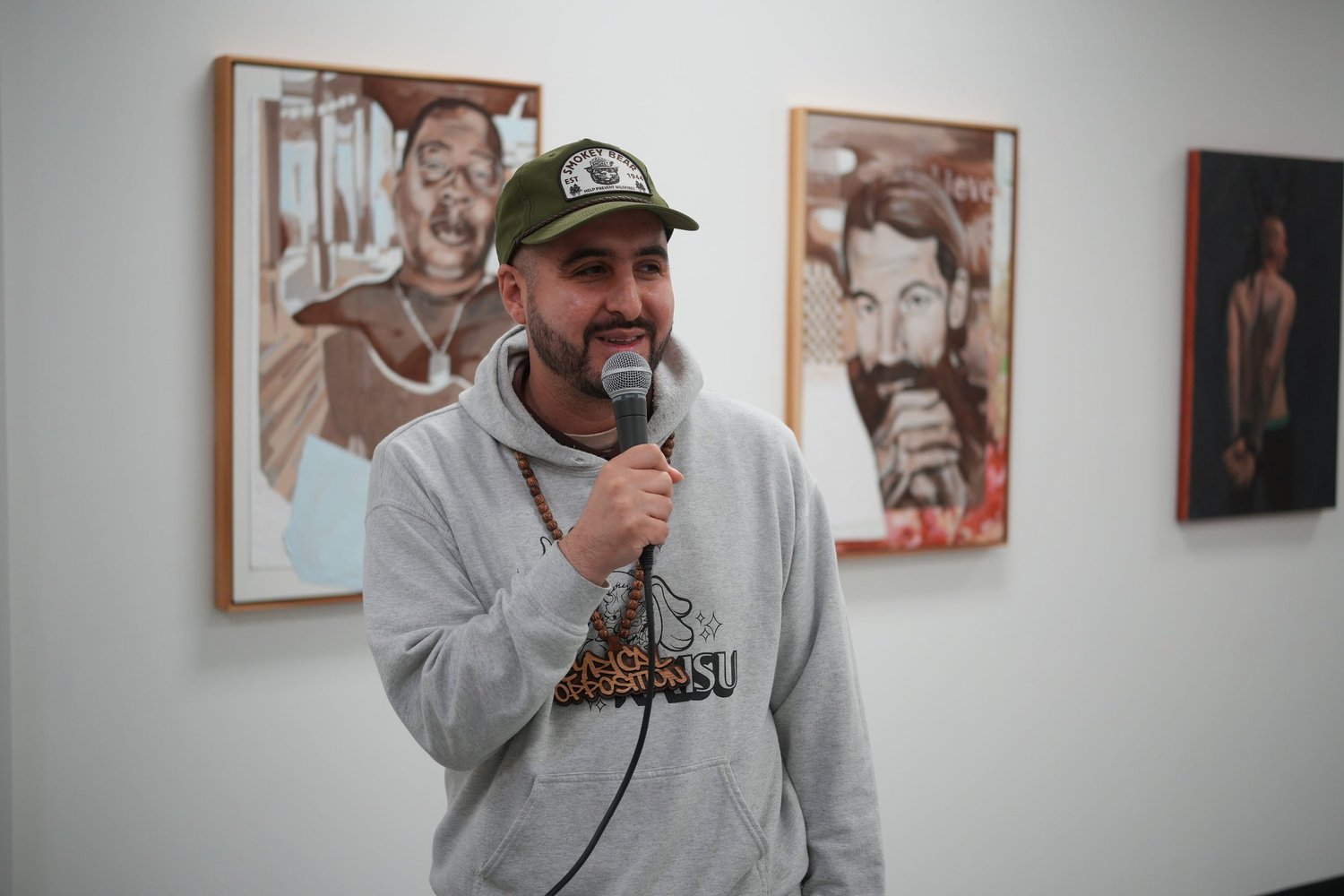 A speaker addresses visitors with a microphone.