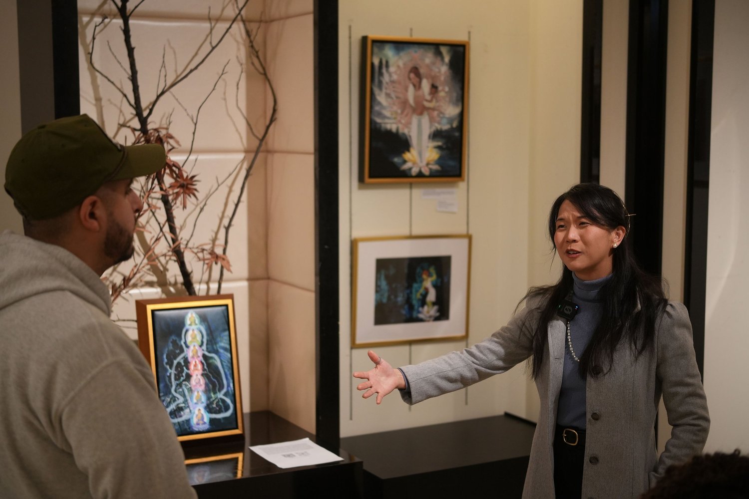 Visitors converse in the art-filled exhibition space.
