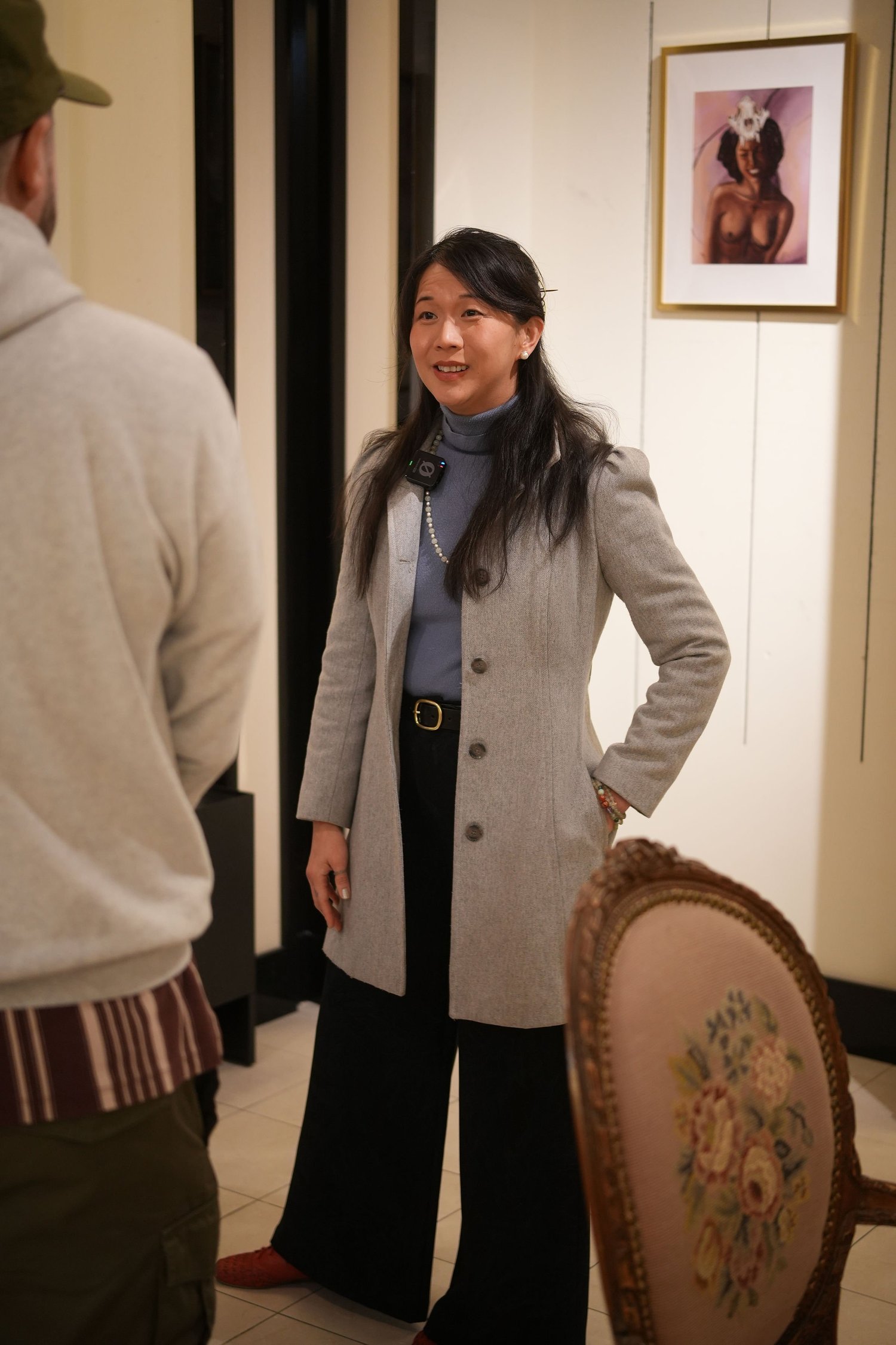 Visitors converse among the gallery artwork.