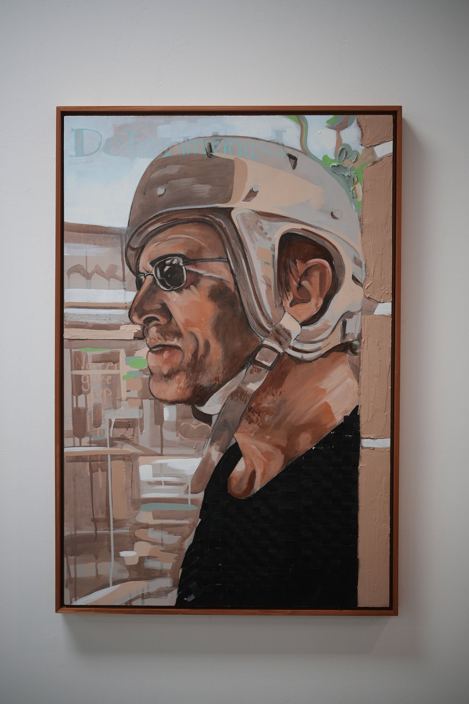 A framed painted portrait of a person in a helmet.