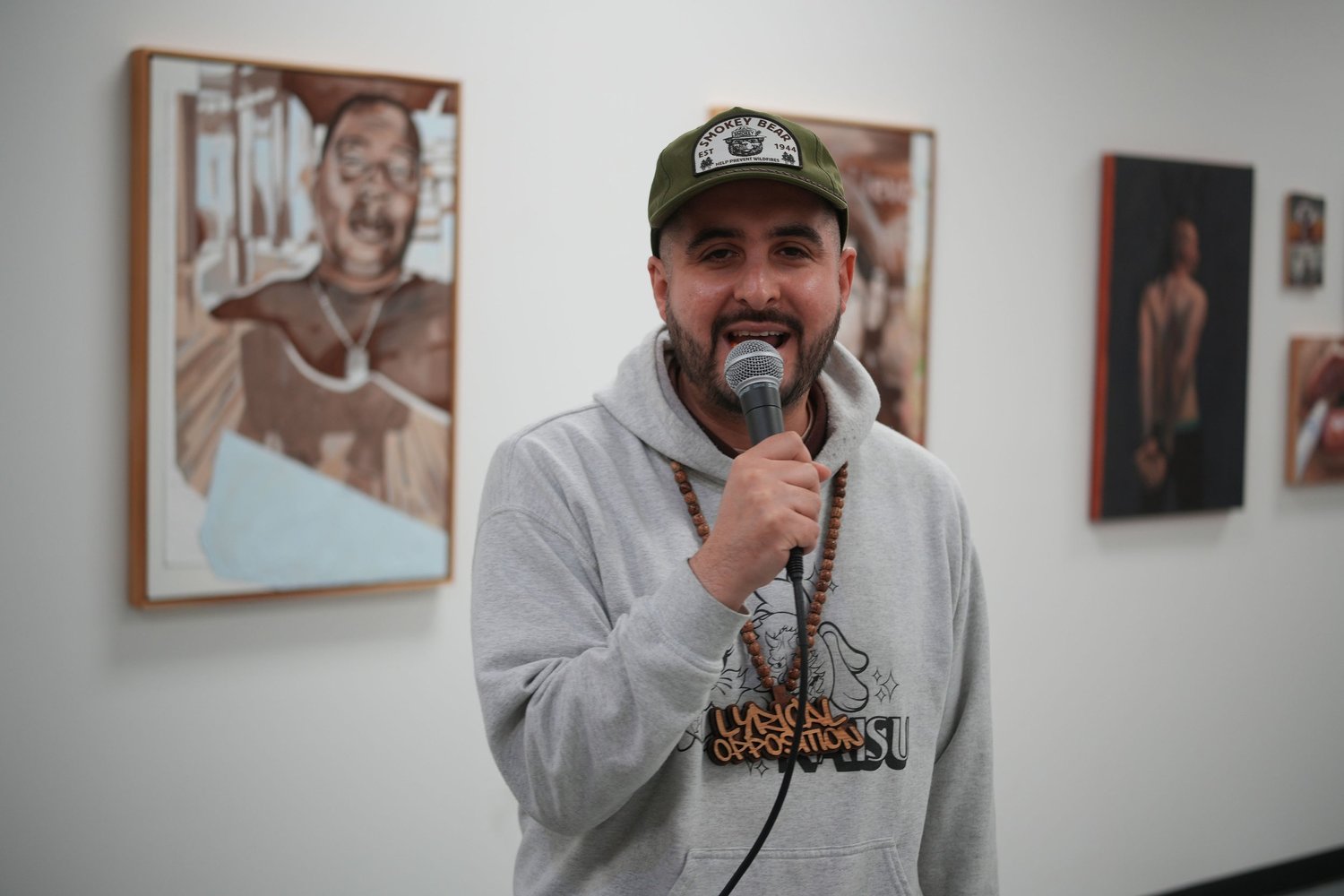 A speaker addresses visitors with a microphone.