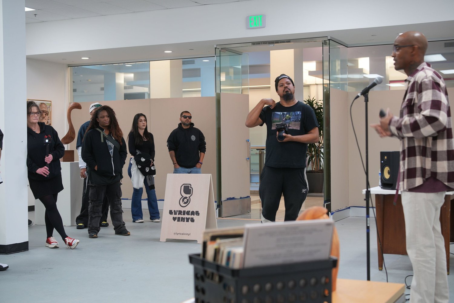 A speaker addresses visitors with a microphone.