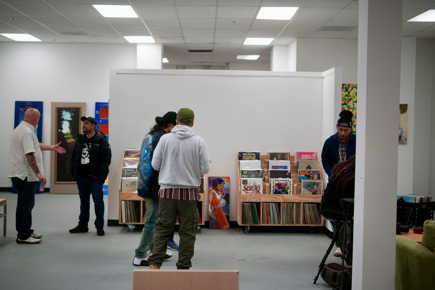 Visitors converse among the gallery artwork.