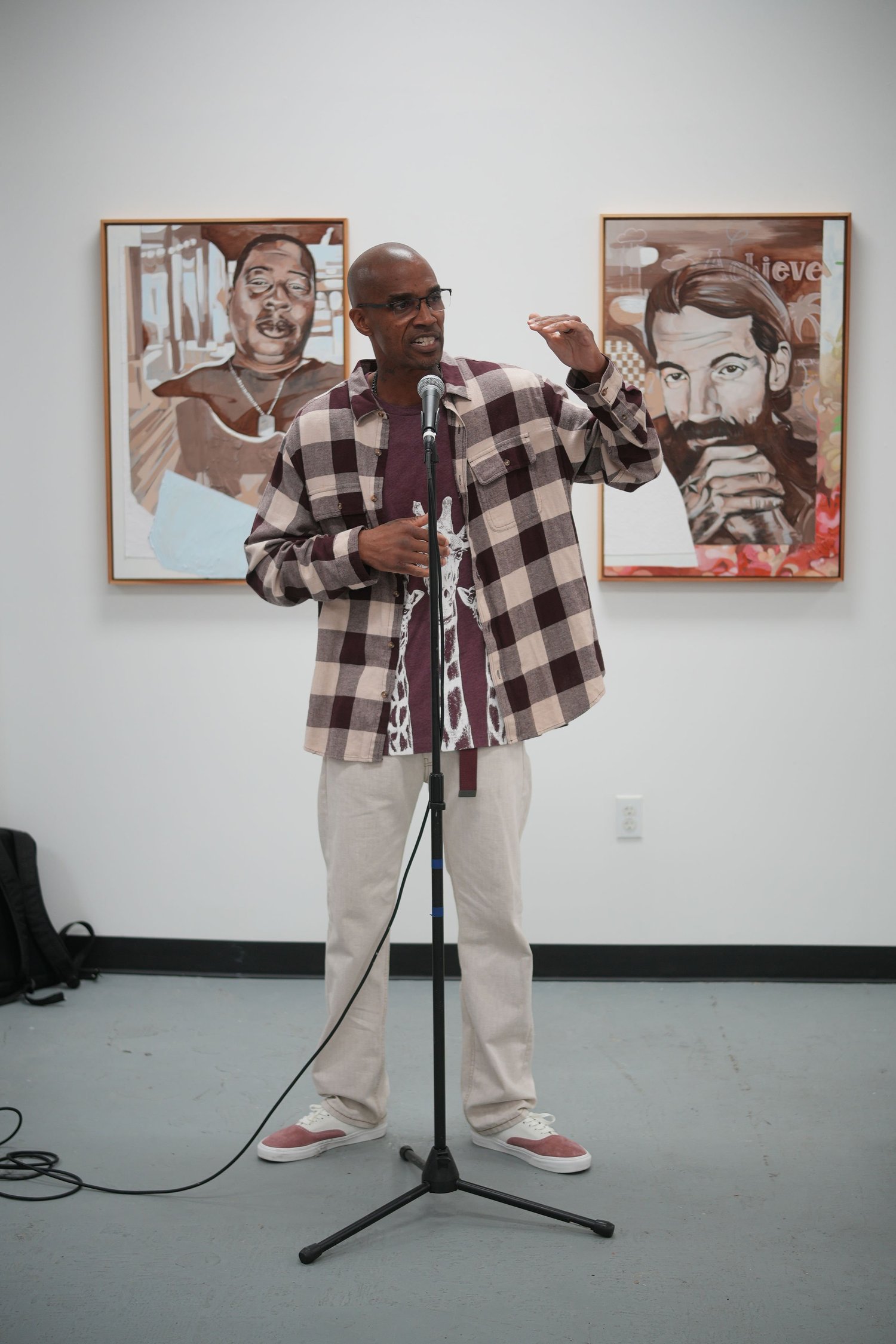 A speaker addresses visitors with a microphone.