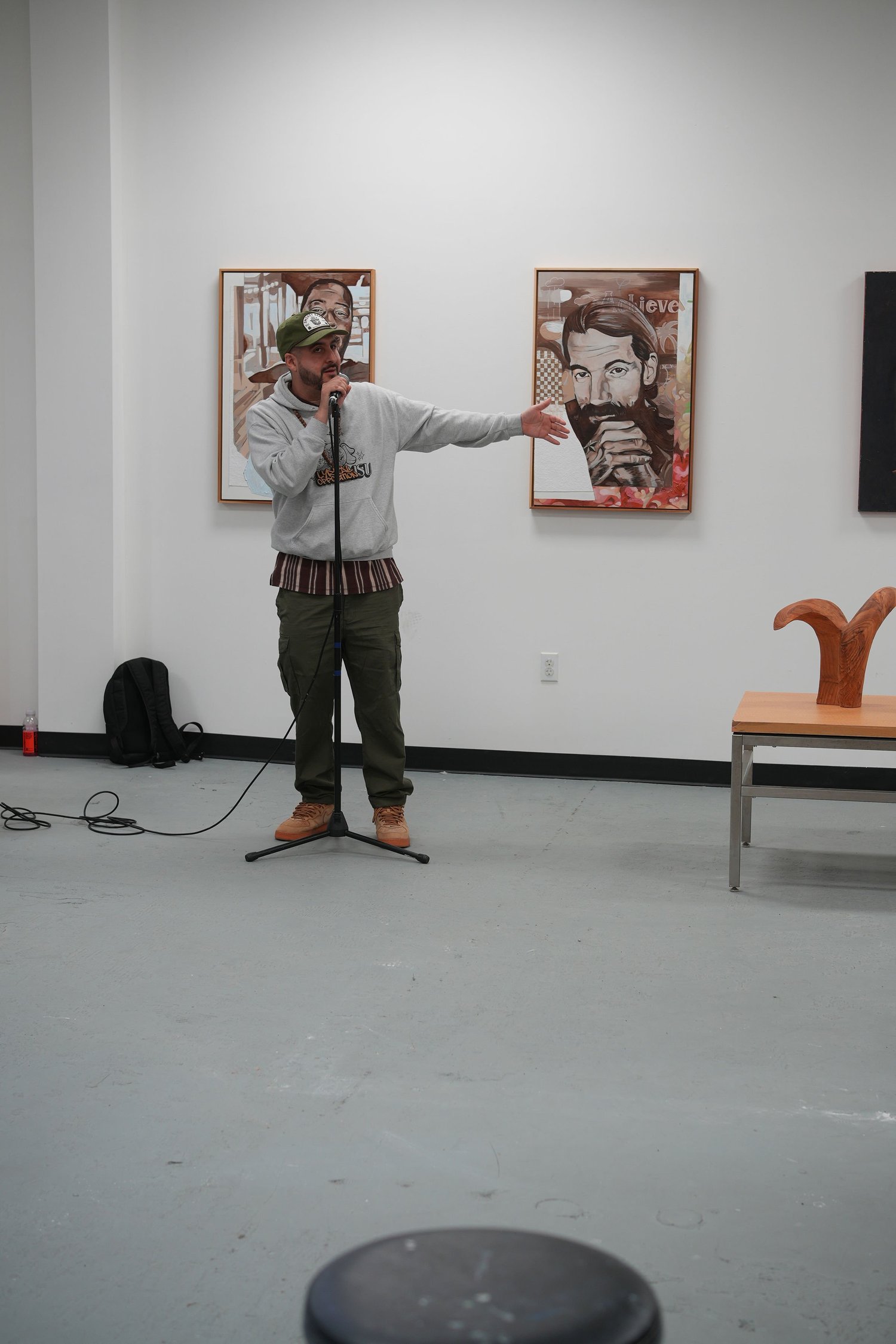 A speaker addresses visitors with a microphone.