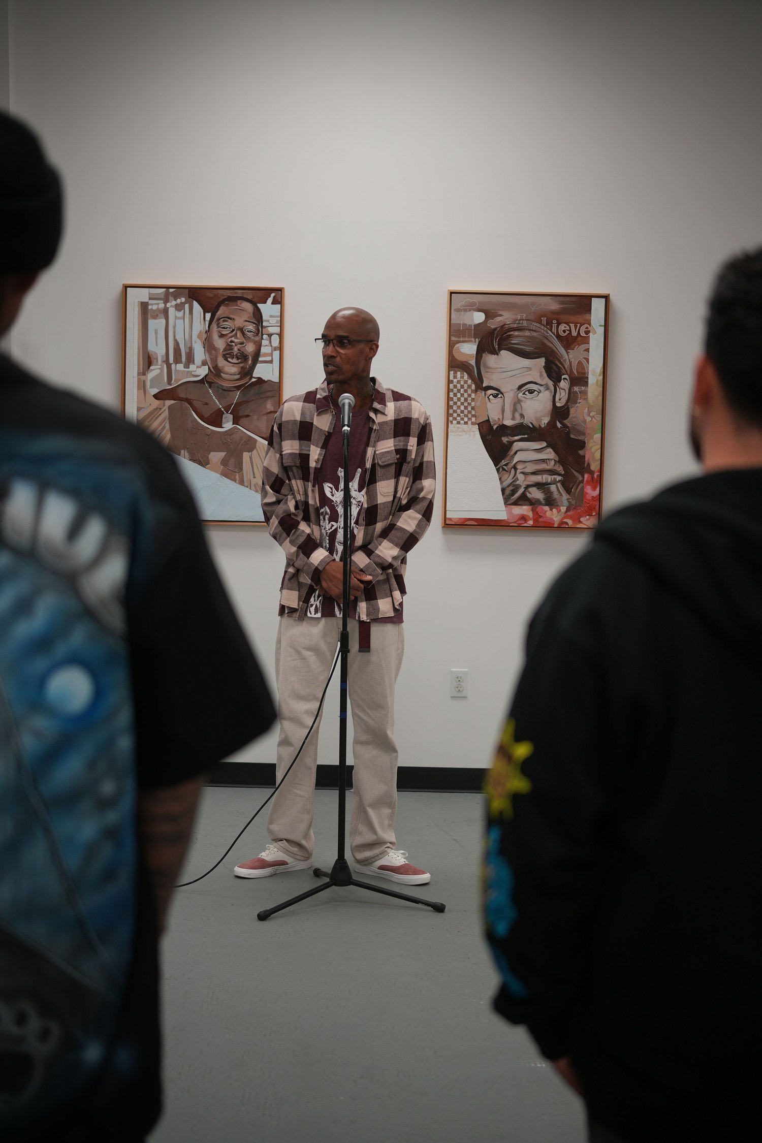 A speaker addresses visitors with a microphone.