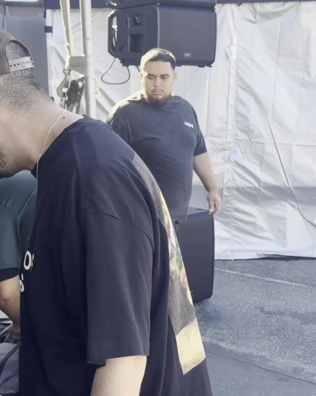 Crew members beside a tent during the Millbrae Art & Wine Festival stage setup.
