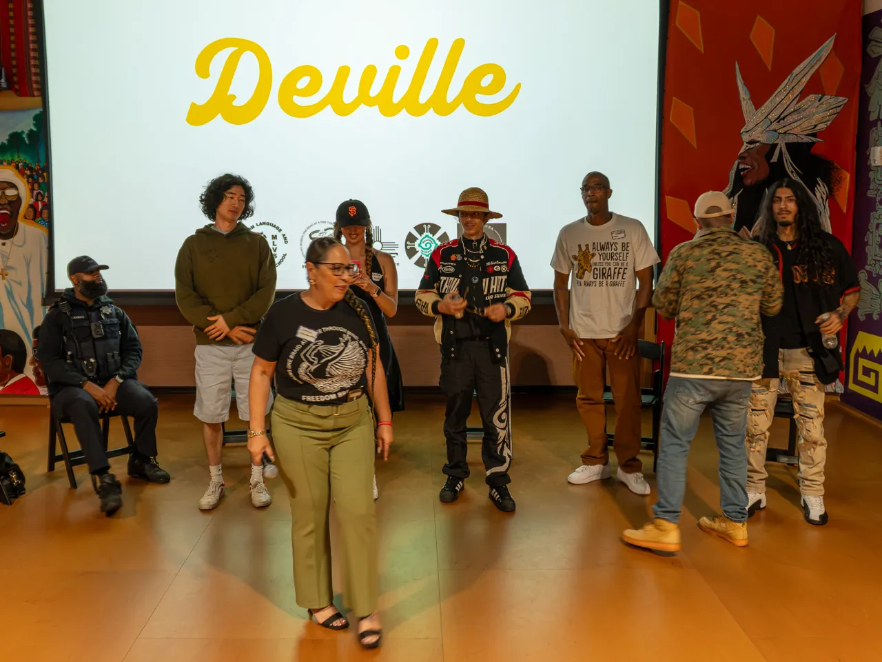 Guests begin standing in front of the screen after the seated discussion.