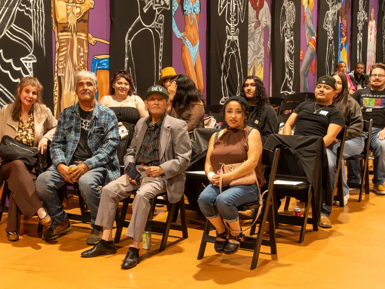Guests seated in the front rows look toward the camera.