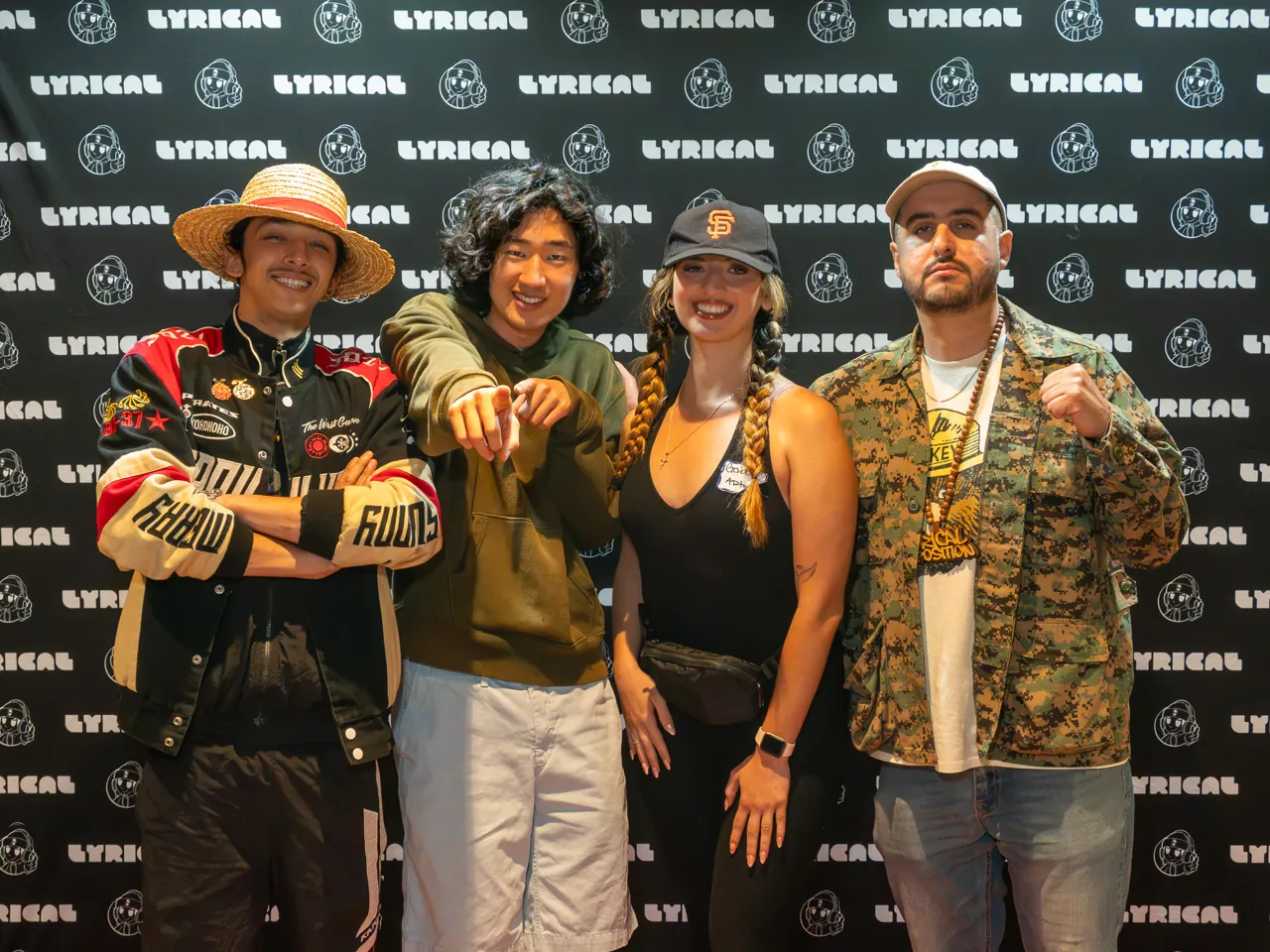 Four guests pose together at the event photo backdrop.
