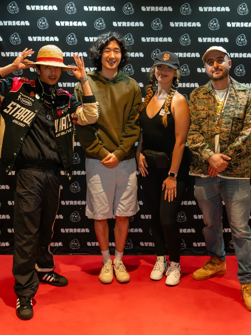 Four guests pose together at the event photo backdrop.