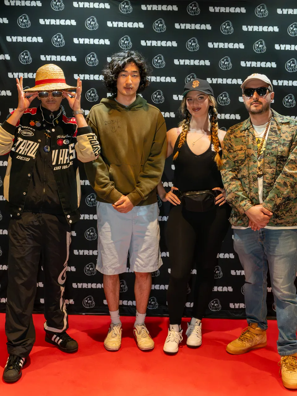 Four guests pose together at the event photo backdrop.