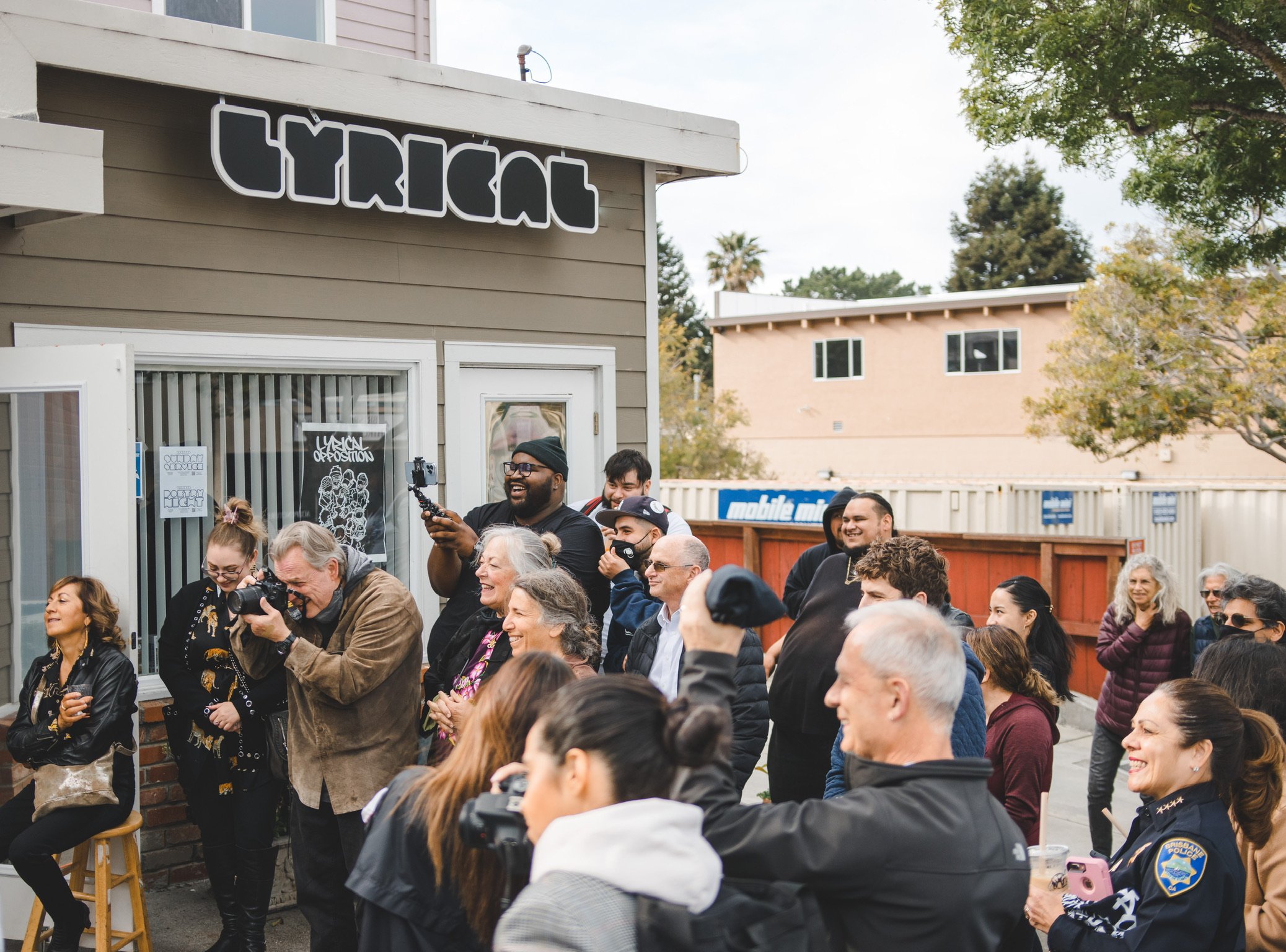 Artists and neighbors gathered outside the LYRICAL community space in Brisbane.