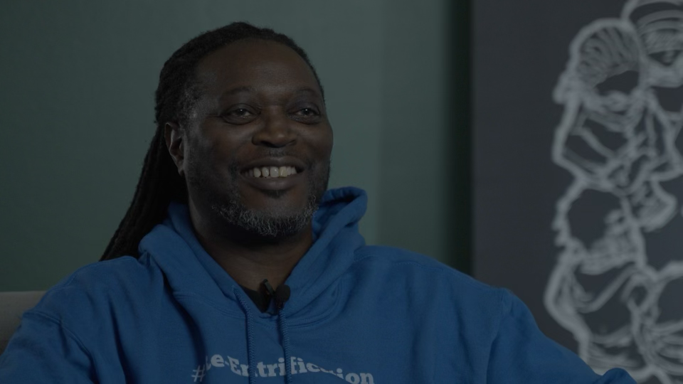 Interview subject smiling in a blue hoodie.
