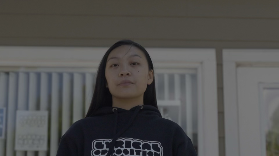 A person standing in front of a house.
