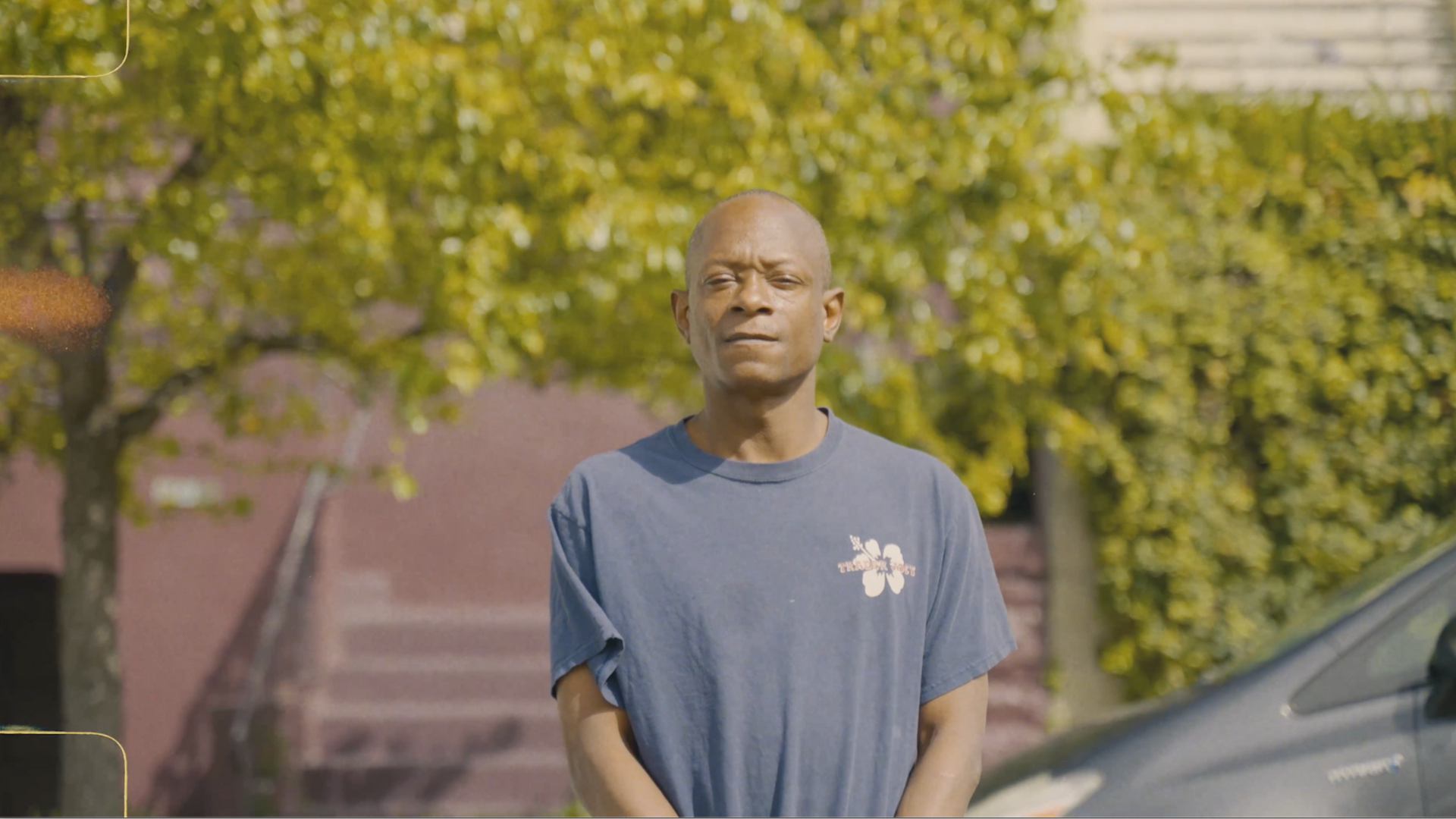 A person standing on a residential street.