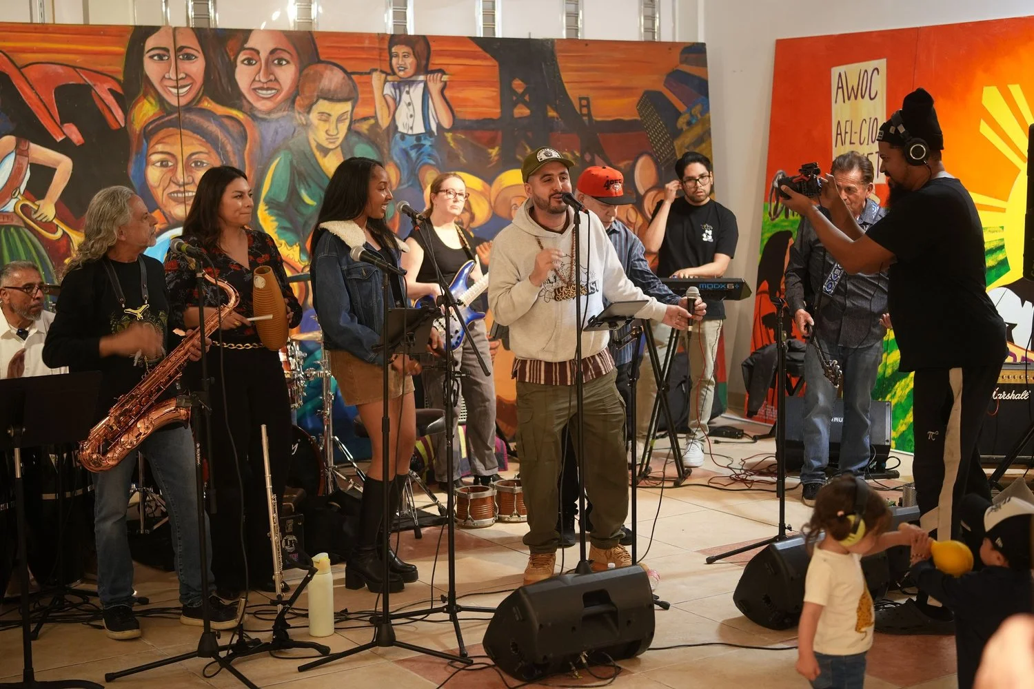 Vocalists and instrumentalists perform together in the gallery.