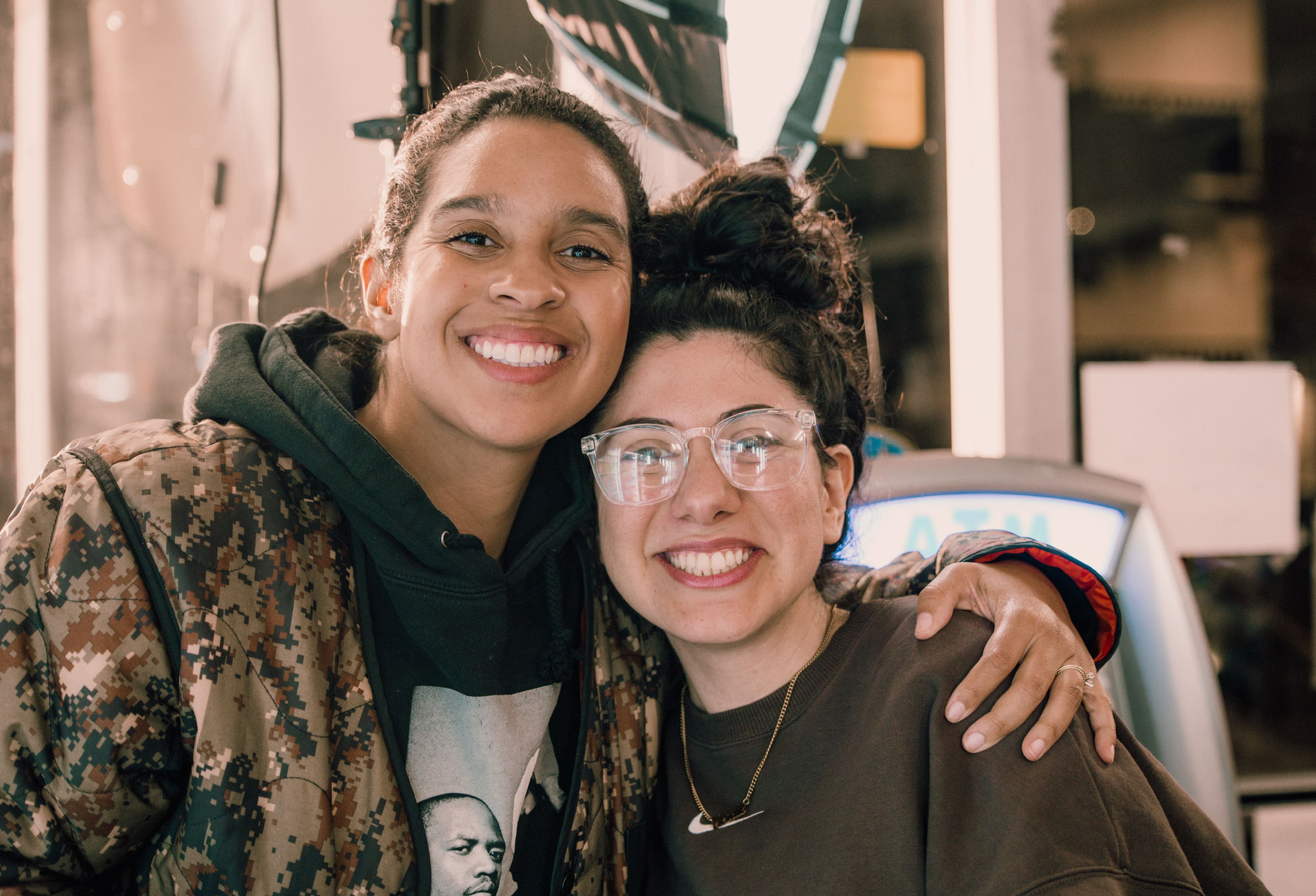 Two crew members with their arms around each other, smiling on location.