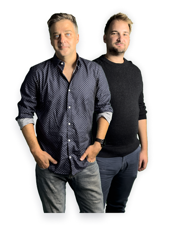 Two casually dressed men standing side by side against a transparent background.