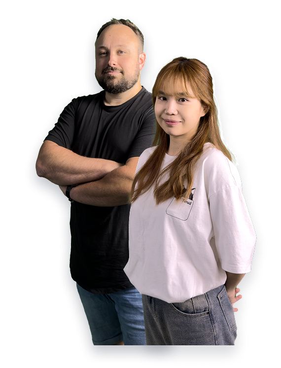 Man with beard wearing black t-shirt and shorts standing with arms crossed next to woman with long hair wearing white t-shirt and jeans.