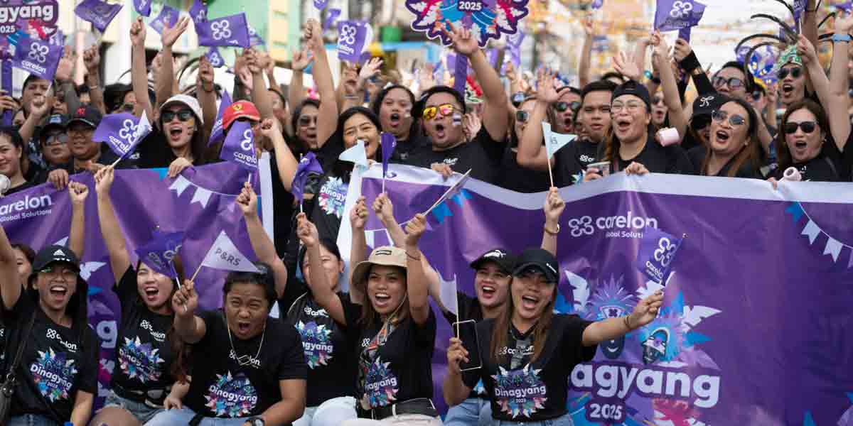 Carelon Global Solutions Philippines employees cheer with Carelon flags and banners at the Dinagyang Festival in Iloilo City