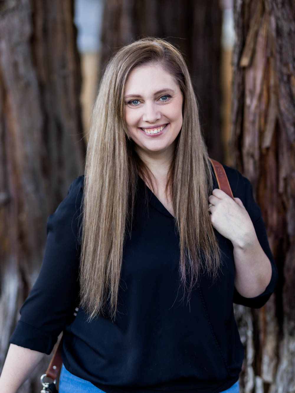 Portrait of Ashley Larcom In front of trees
