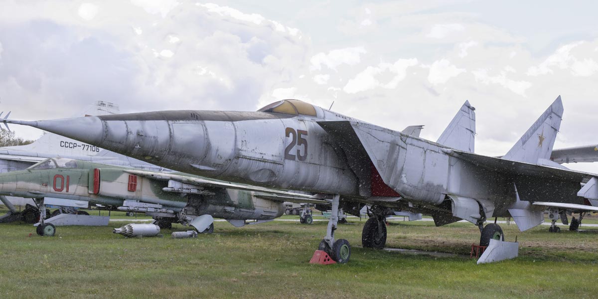 A grounded jet on grassy fields with other jets.