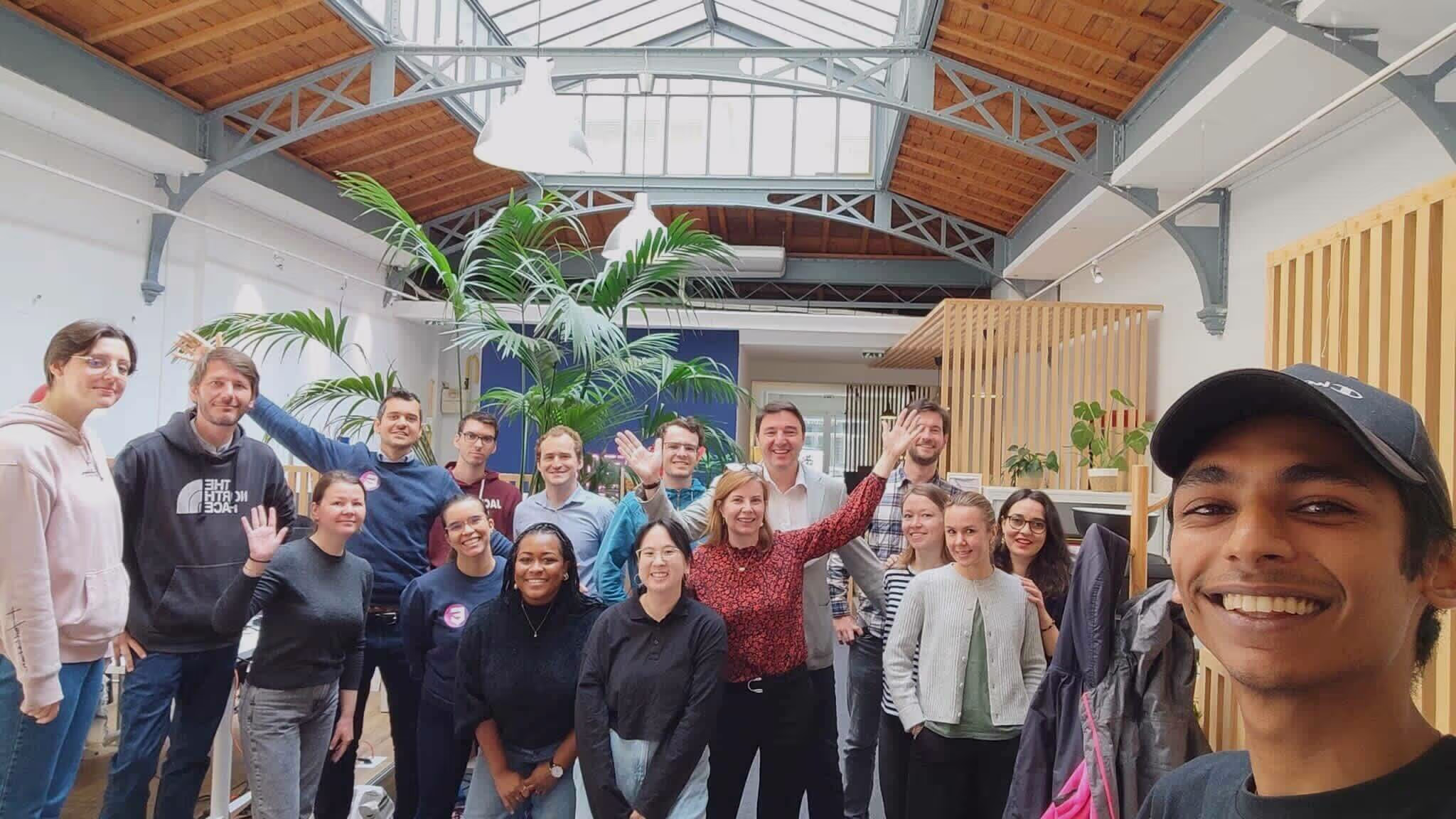 A group of people posing for a picture in a large room.