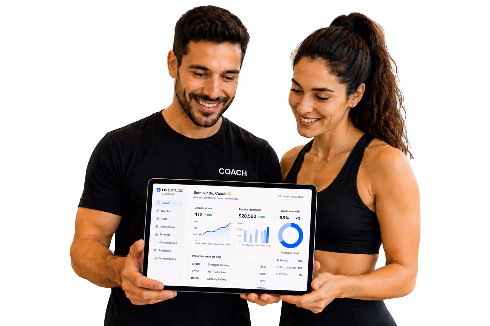 Smiling male and female fitness coaches holding a tablet showing a dashboard with client and revenue stats.