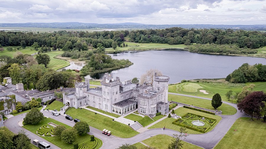 Exterior of Dromoland Castle hotel reflected in the lake, County Clare, Ireland 