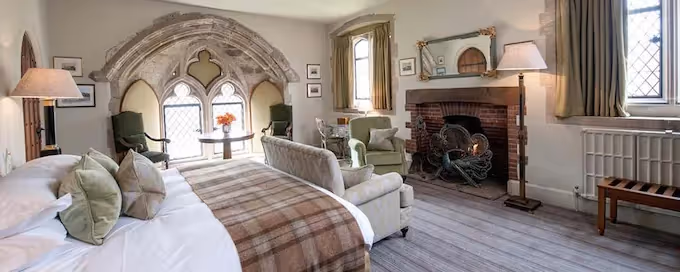 Boutique bedroom at Amberley Castle with exposed beams and heritage decor