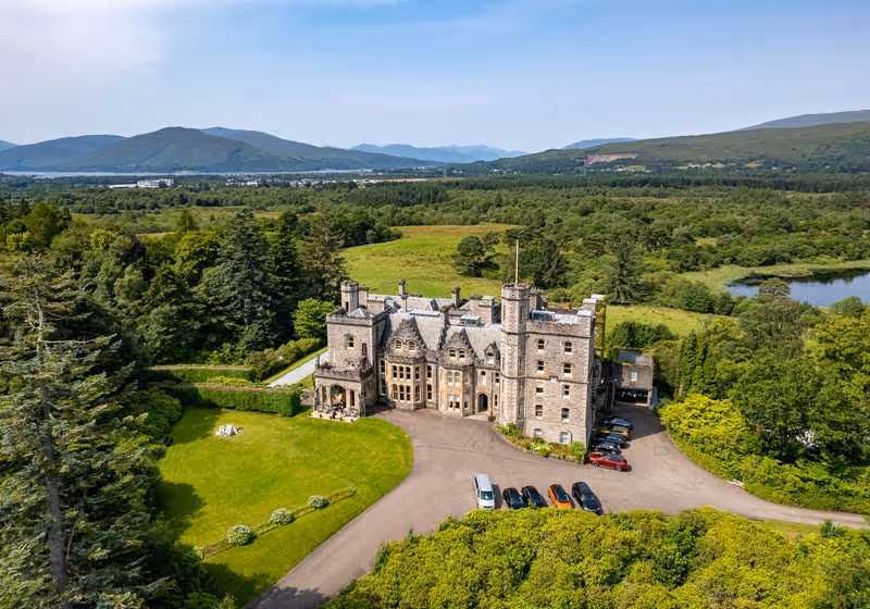 Inverlochy Castle exterior with loch and Ben Nevis backdrop, Highlands