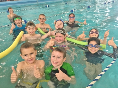 Children learning to swim in the swimming pool at North County Recreation District in Nehalem, Oregon.
