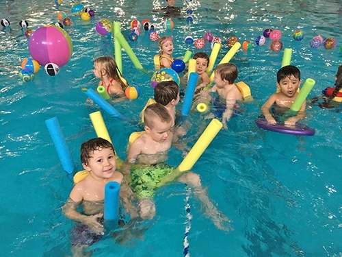 Children learning to swim in the swimming pool at North County Recreation District in Nehalem, Oregon.