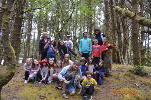 Children in the woods posing for a portrait with the Youth Program at North County Recreation District in Nehalem, Oregon