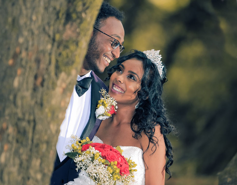 A bride smiles at her groom