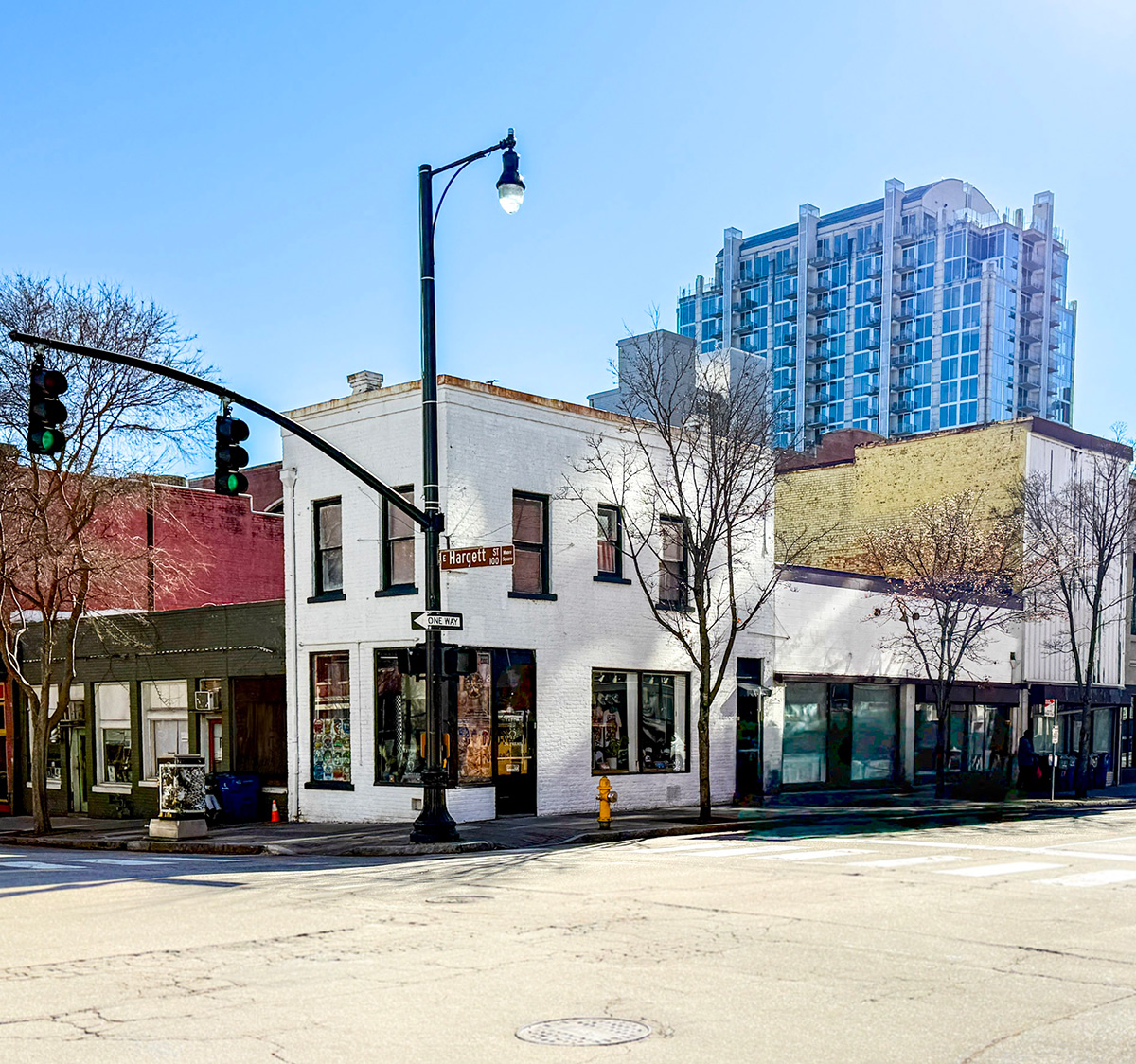 a photo of 4 buildings on a street corner