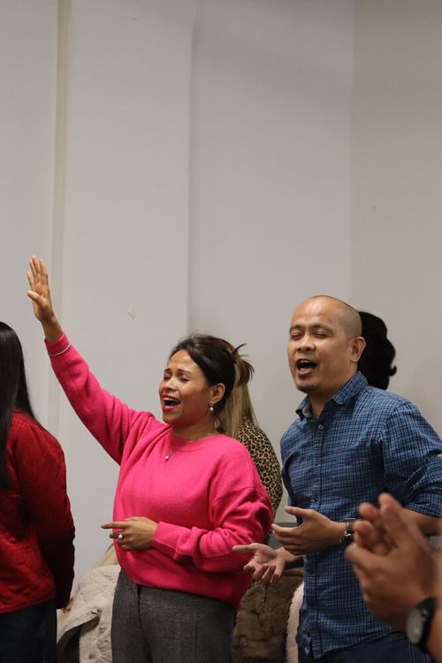 Man and woman worshipping at The Lighthouse Centre in Brussels